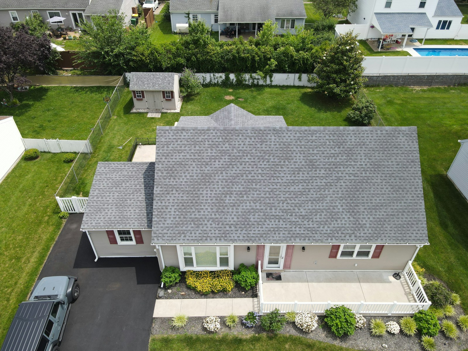 Aerial view of a suburban house with a grey roof